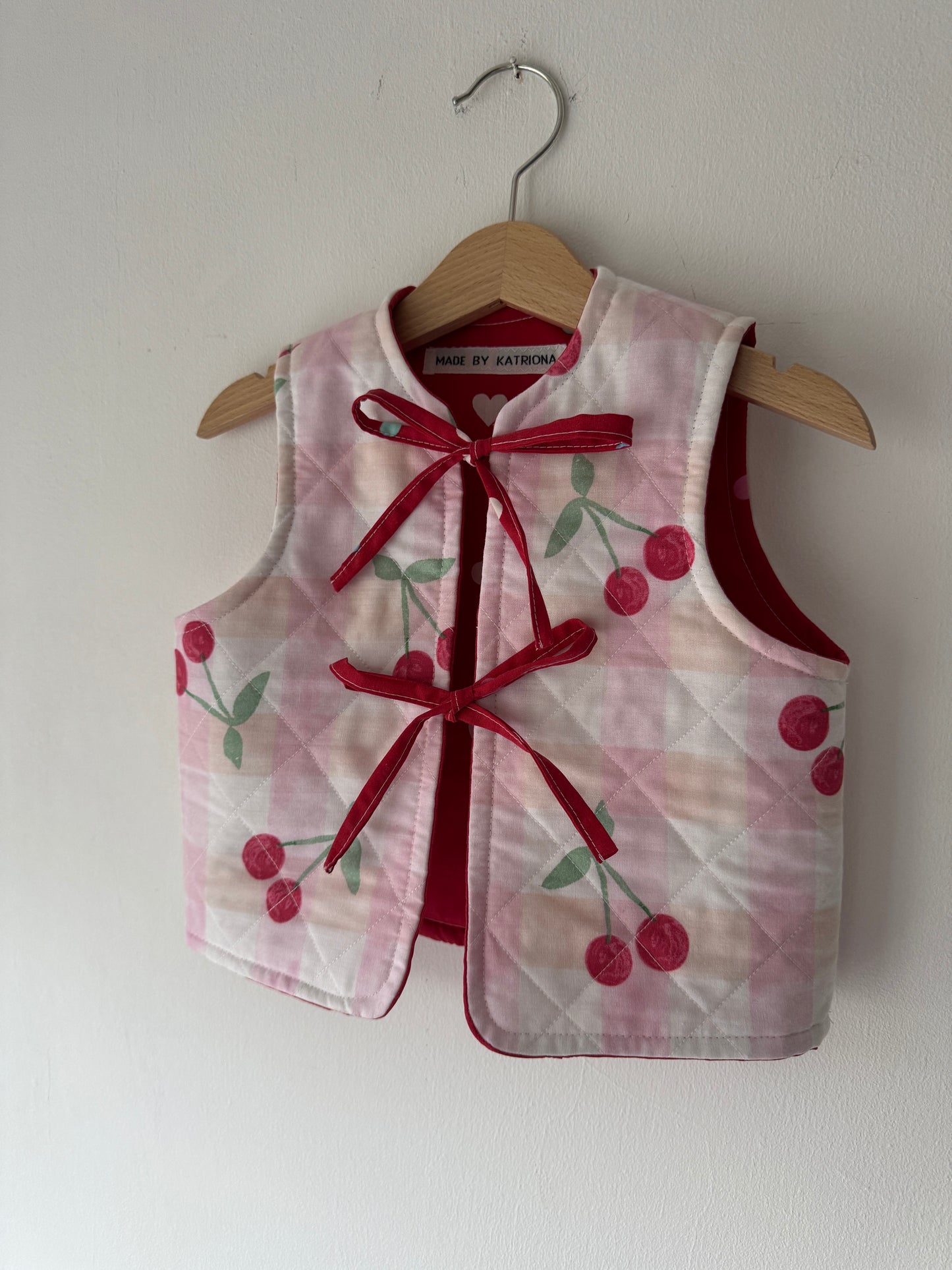 Cherry/hearts reversible quilted gilet 1-2 years