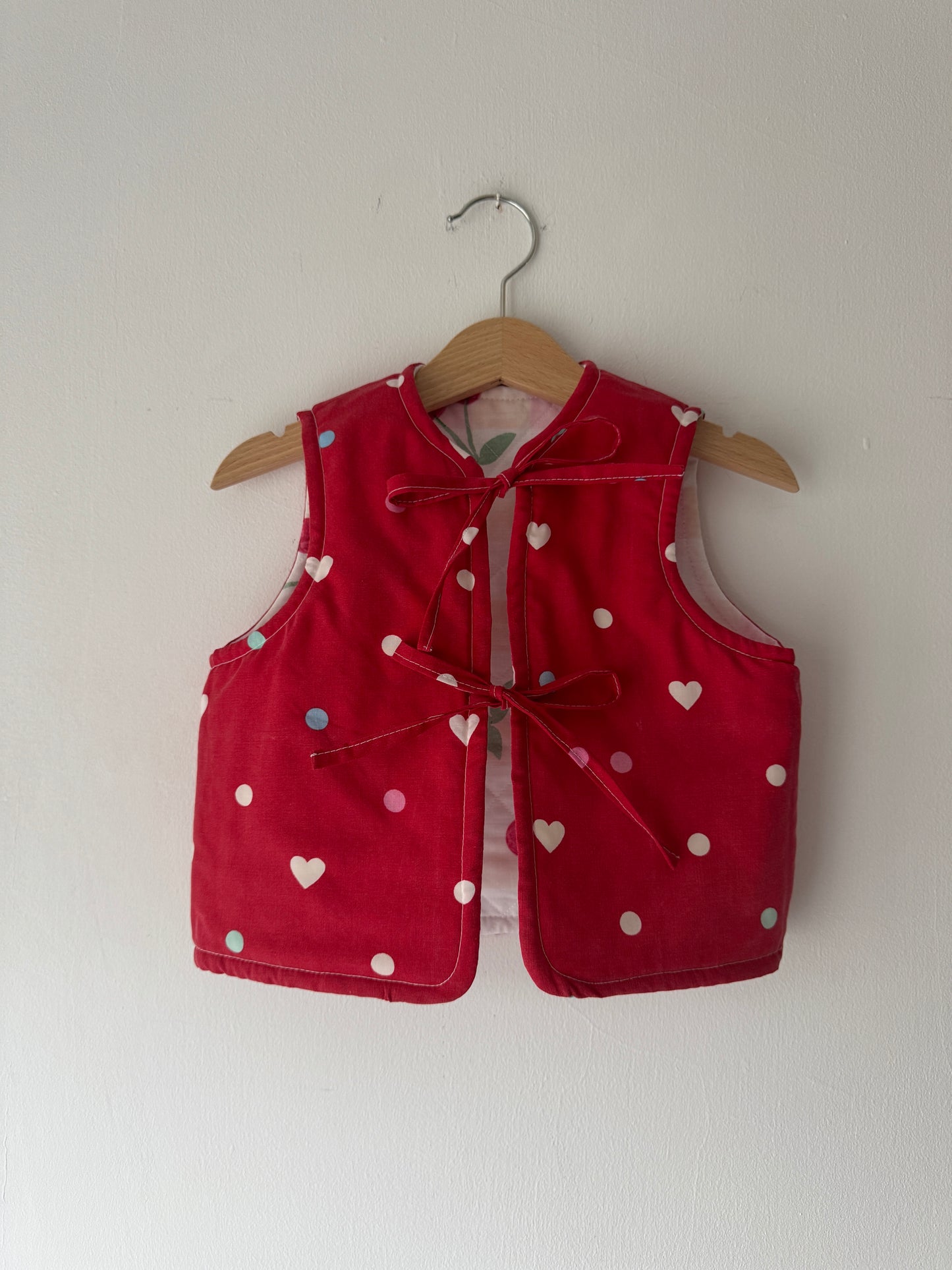 Cherry/hearts reversible quilted gilet 1-2 years
