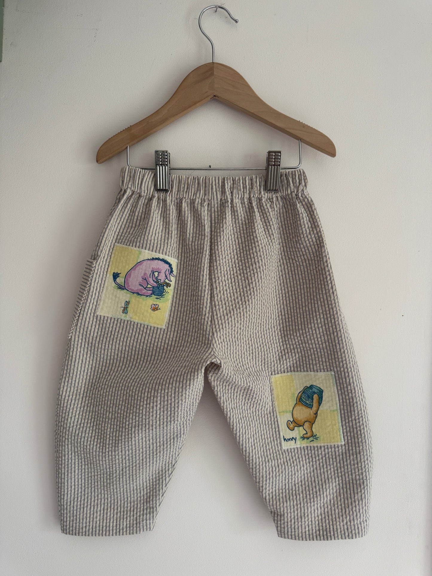 Striped barrel leg pants with Winnie the Pooh patches 2-3 years