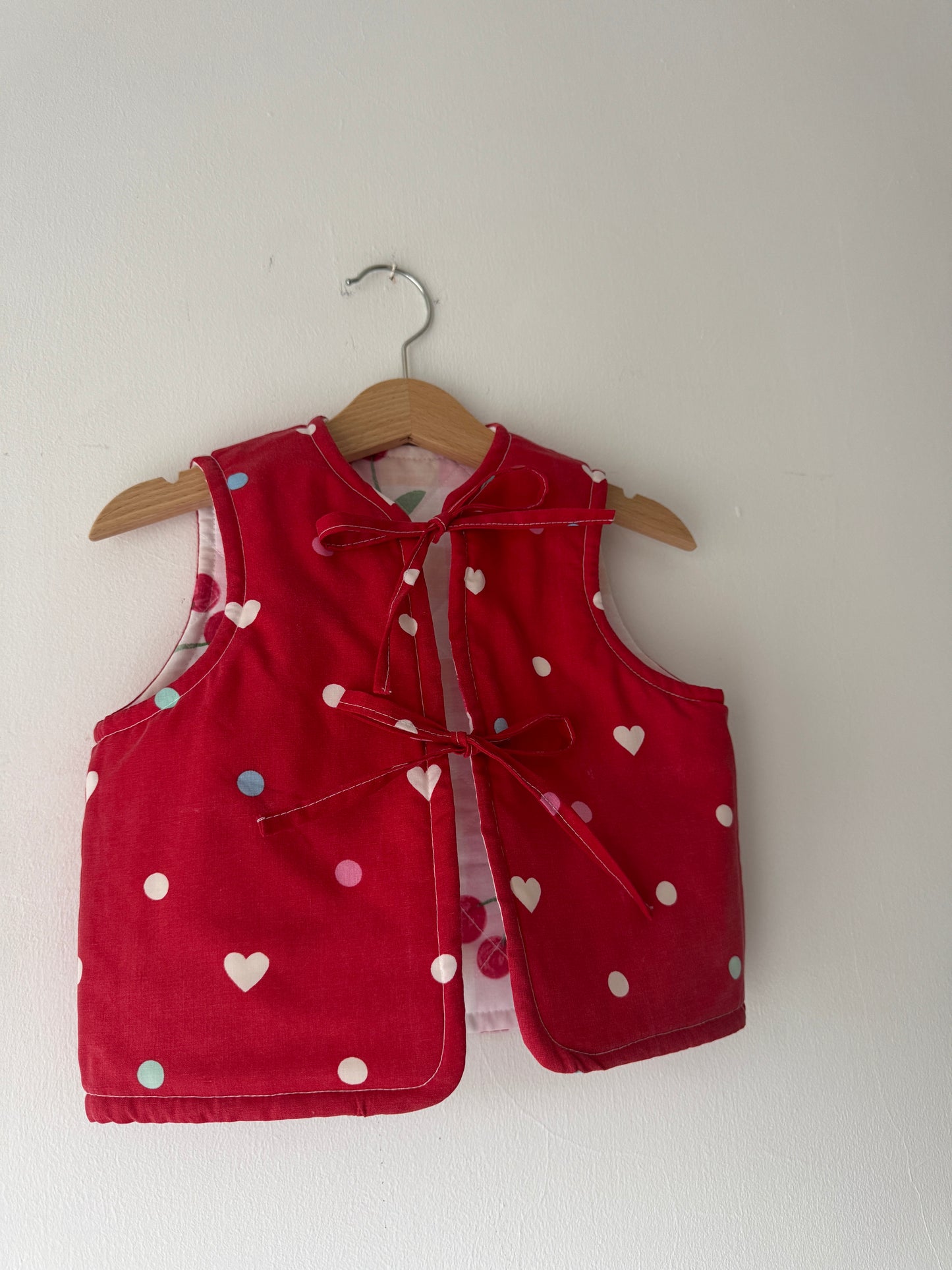 Cherry/hearts reversible quilted gilet 1-2 years