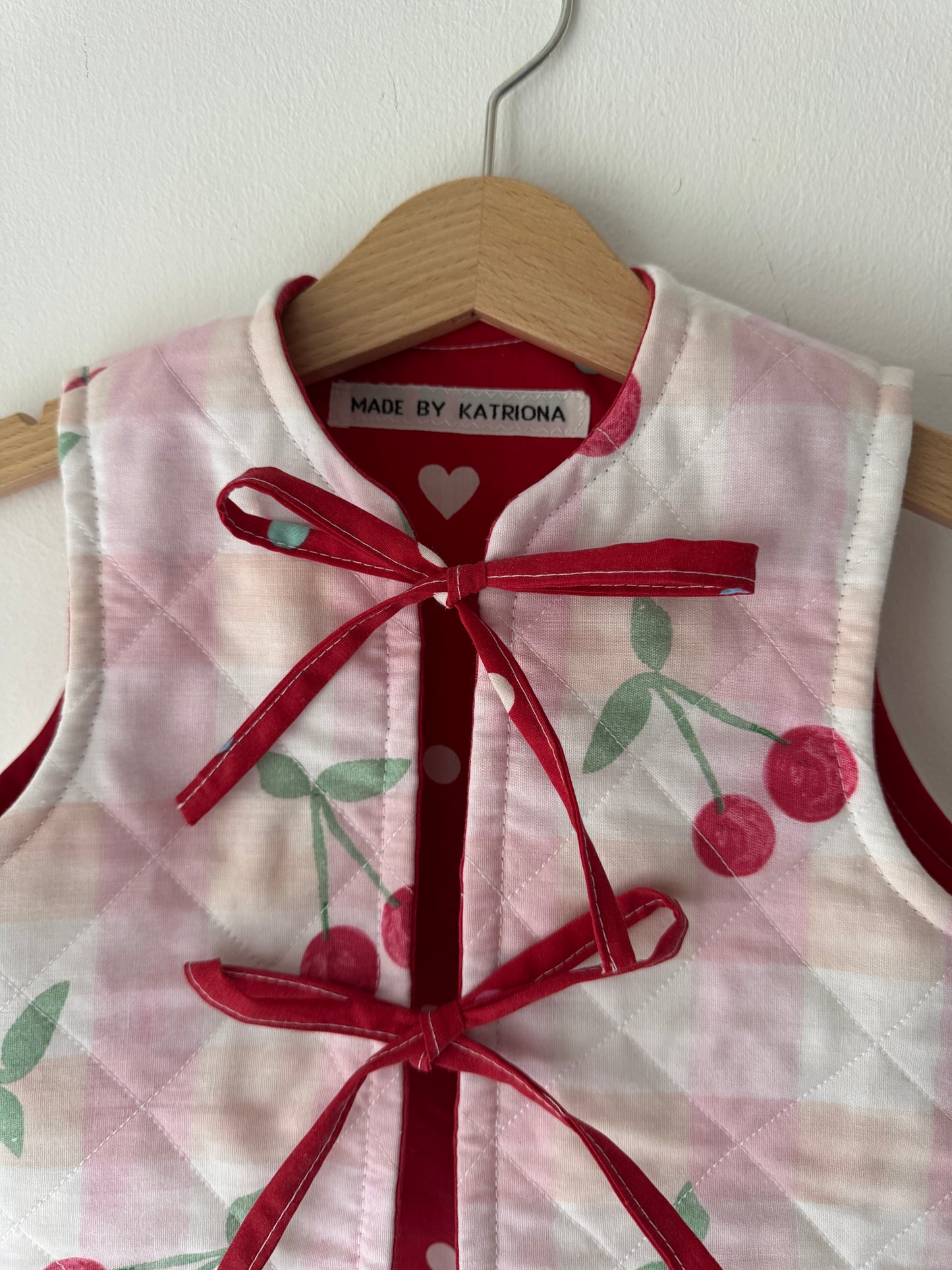Cherry/hearts reversible quilted gilet 1-2 years