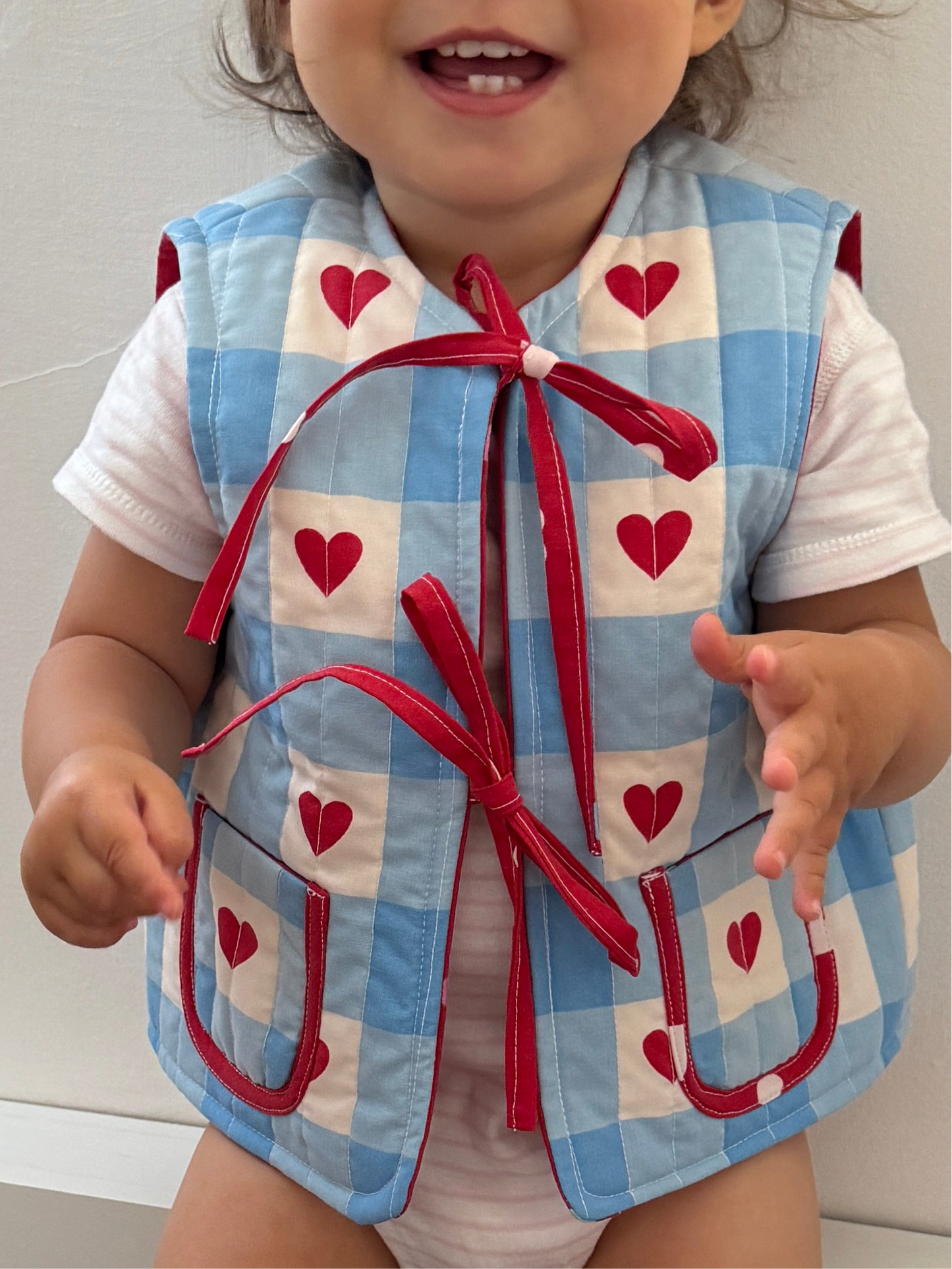 Cherry/hearts reversible quilted gilet 1-2 years