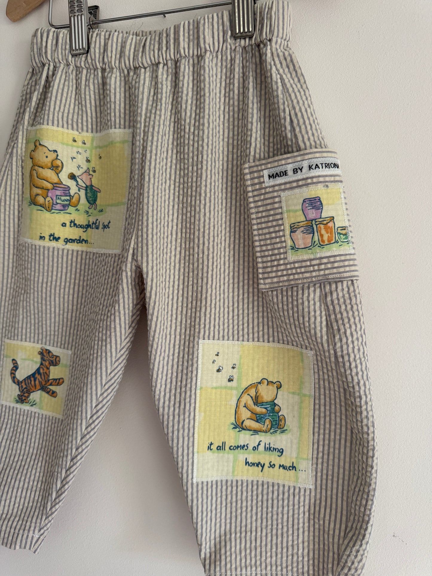 Striped barrel leg pants with Winnie the Pooh patches 2-3 years