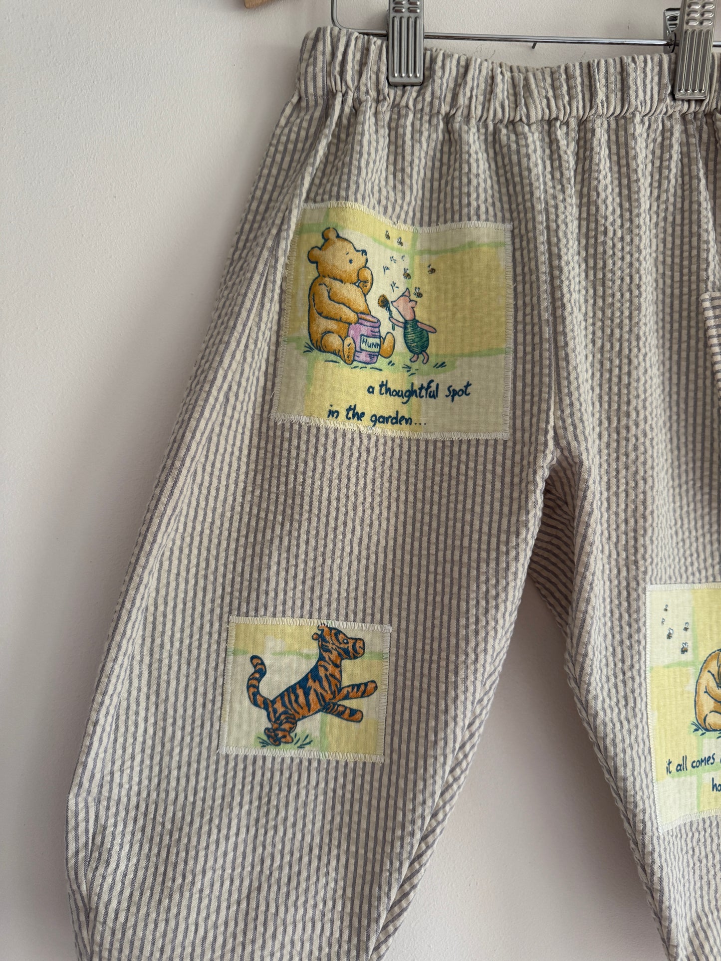 Striped barrel leg pants with Winnie the Pooh patches 2-3 years